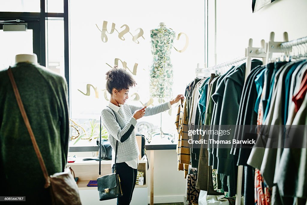 Woman taking photo of clothing with smartphone