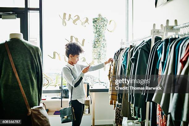 woman taking photo of clothing with smartphone - luxury apparel bildbanksfoton och bilder