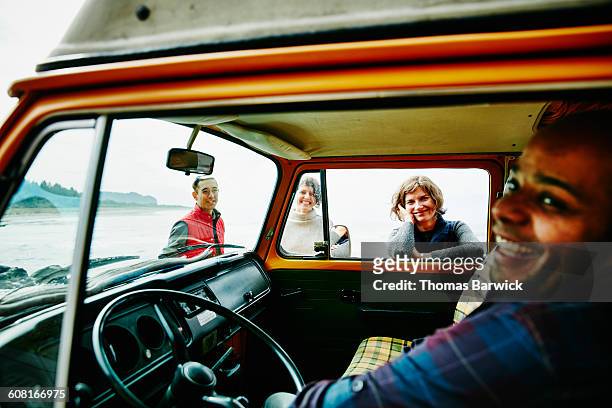 laughing group of friends on road trip - four people in car stock pictures, royalty-free photos & images