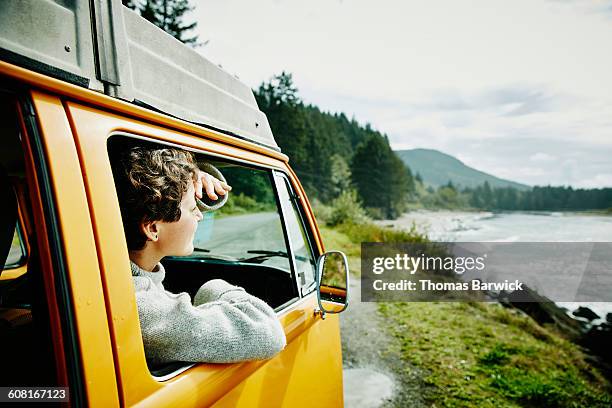 smiling woman in passenger seat of van looking out - opportunity bildbanksfoton och bilder