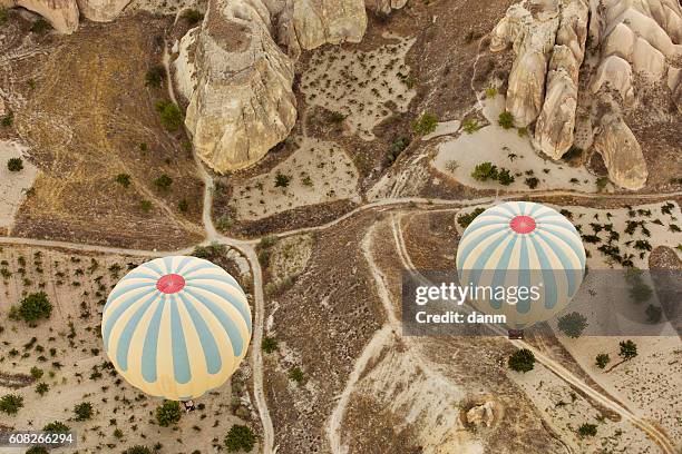 colorful hot air balloons flying over red valley at cappadocia, anatolia, turkey. volcanic mountains in goreme national park. - tipo de roca fotografías e imágenes de stock