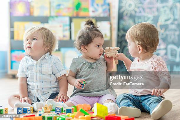 learning to share - group of babies stock pictures, royalty-free photos & images