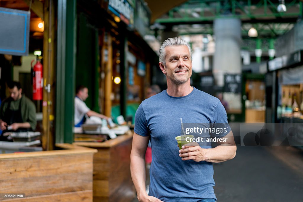 Healthy man having a smoothie