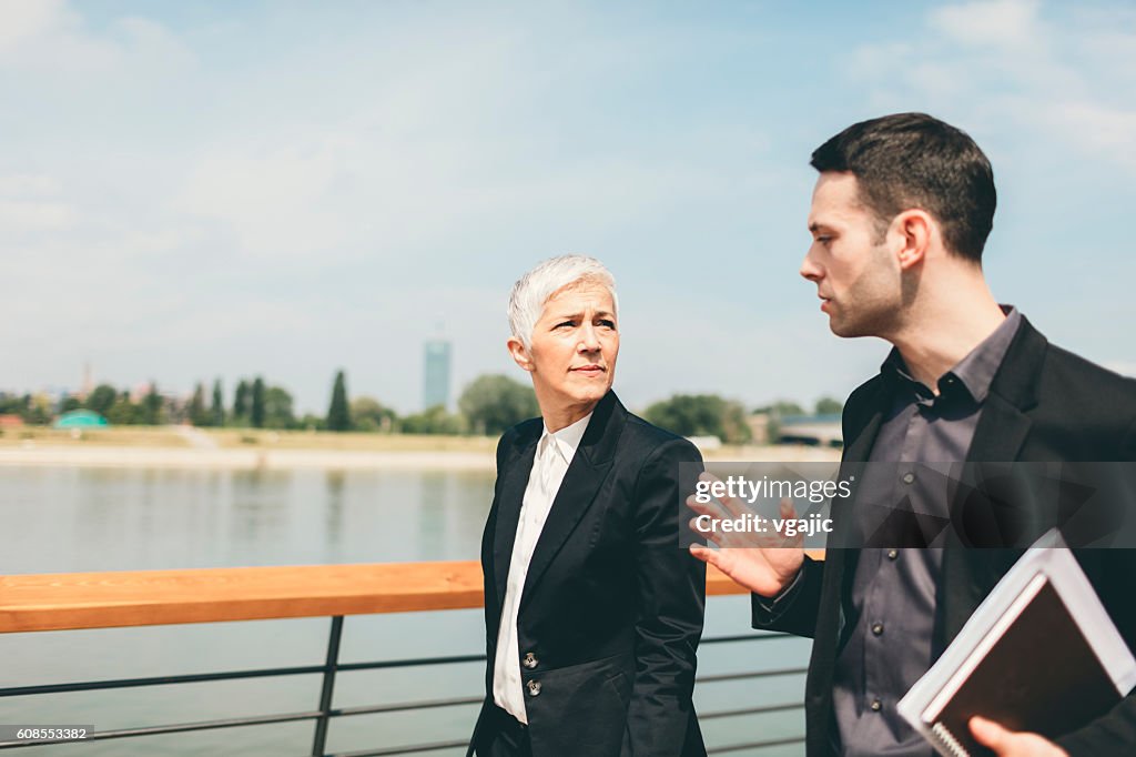 Businesspeople Walking and Talking Outdoors.