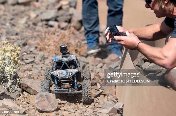 Man takes a video of a remote control car affixed with a GoPro HERO5 Session during a press event in Olympic Valley, California on September 19, 2016.