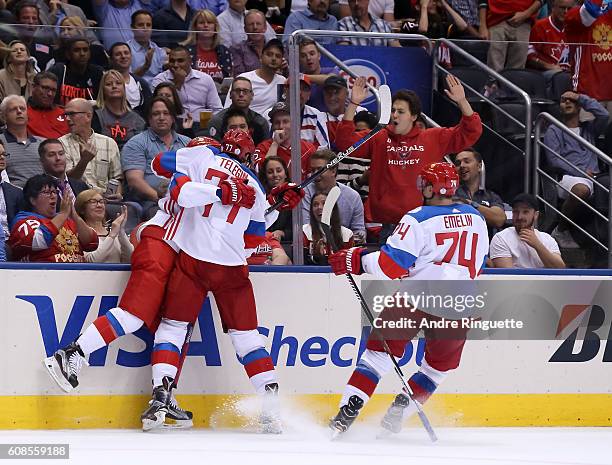 Vladislav Namestnikov celebrates with Ivan Telegin and Alexei Emelin of Team Russia after scoring a second period goal on Team North America during...