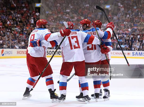 Vladimir Tarasenko celebrates with Alex Ovechkin and Pavel Datsyuk of Team Russia after scoring a second period goal on Team North America during the...