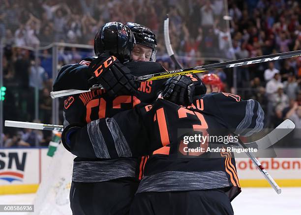 Ryan Nugent-Hopkins celebrates with Johnny Gaudreau of Team North America after scoring a third period goal on Team Russia during the World Cup of...