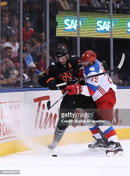 Andrei Markov of Team Russia collides with Sean Couturier of Team North America along the boards during the World Cup of Hockey 2016 at Air Canada...