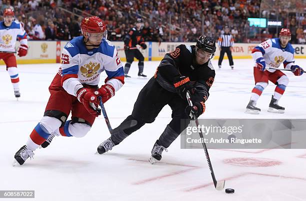 Johnny Gaudreau of Team North America stickhandles the puck with pressure from Nikita Zaitsev of Team Russia during the World Cup of Hockey 2016 at...