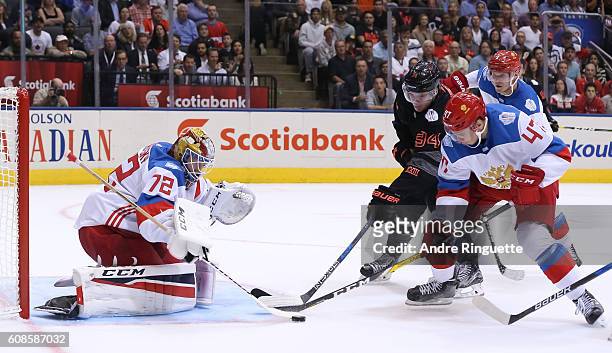 Auston Matthews of Team North America battles for a loose puck with Alexey Marchenko in front of Sergei Bobrovsky of Team Russia during the World Cup...