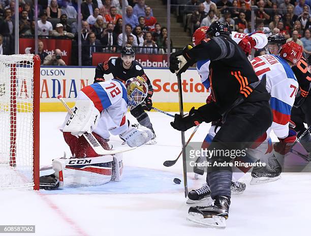 Sergei Bobrovsky of Team Russia jumps on a loose puck with Jack Eichel of Team North America in front during the World Cup of Hockey 2016 at Air...