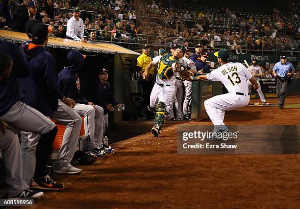Bruce Maxwell of the Oakland Athletics catches a foul ball hit by Carlos Correa of the Houston Astros in the seventh inning at Oakland-Alameda County...