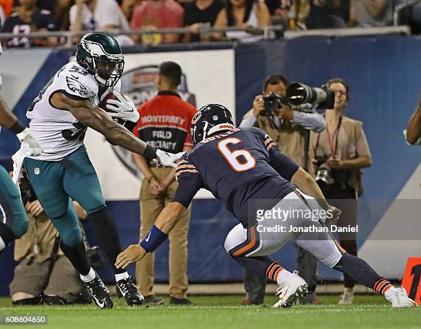 Jay Cutler of the Chicago Bears moves to try and tackle Nigel Bradham of the Philadelphia Eagles after Bradham intecepted his pass at Soldier Field...