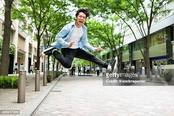 punk rocker jumping in tokyo - japanse man stock pictures, royalty-free photos & images