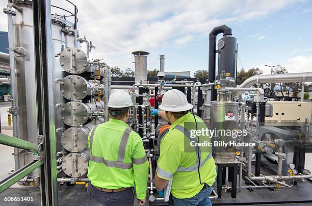 worker inspecting a solid waste processing plant - biofuels stock pictures, royalty-free photos & images