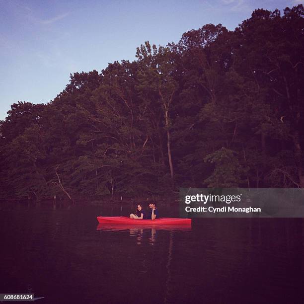 twilight kayak - family red canoe stock pictures, royalty-free photos & images