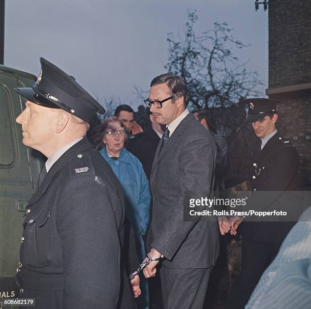 Bruce Reynolds , mastermind of the 1963 Great Train Robbery, secured with handcuffs to two prison officers, enters court in Linslade, England on 26th...