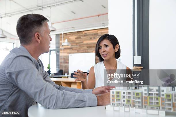 business meeting in open office - leanincollection stock pictures, royalty-free photos & images