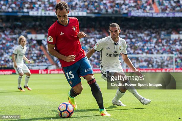 Pepe of Real Madrid battles for the ball with Unai Garcia of Osasuna during the La Liga match between Real Madrid and Osasuna at the Santiago...