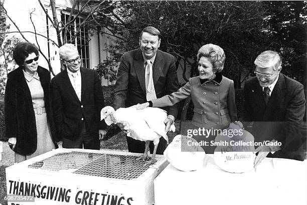 First Lady Pat Nixon accepts a live turkey from representatives of the National Turkey Federation, as well as two frozen turkeys from the Poultry and...