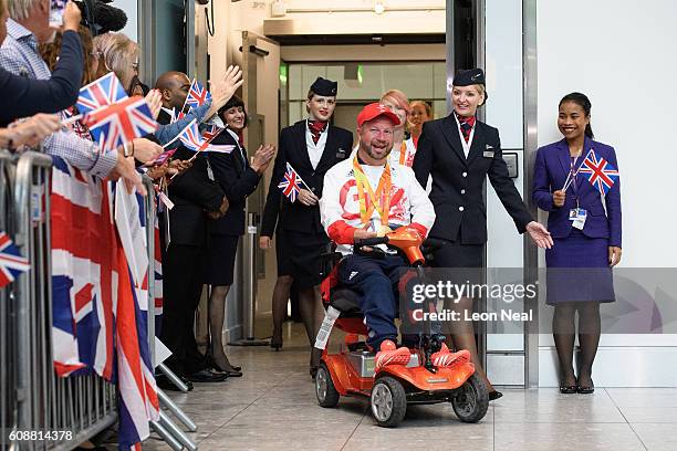 Gold medallist Lee Pearson is greeted by supporters after arriving on British Airways flight BA2016 from Rio de Janeiro to London Heathrow Terminal 5...