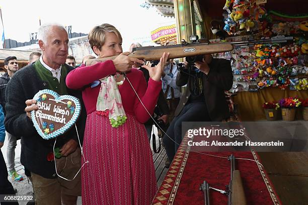 Former Biathlon athlete Magdalena Neuner takes part in a shooting competition with former biathlon athlete Fritz Fischer during the BMW Wiesn...