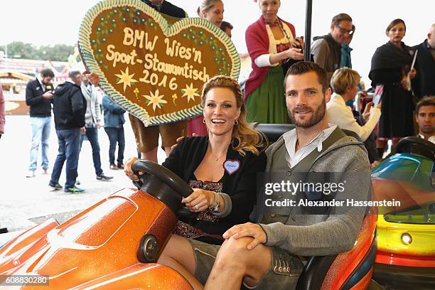 Pilot Martin Tomczyk drives with Christina Surer at the auto scooter during the BMW Wiesn Sport-Stammtisch 2016 at Kafers Wiesn Schaenke beer tent at...