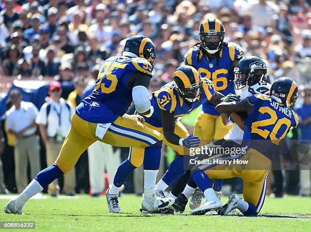 Jermaine Kearse of the Seattle Seahawks is tackled by Lamarcus Joyner and Maurice Alexander during the second quarter of the home opening NFL game...
