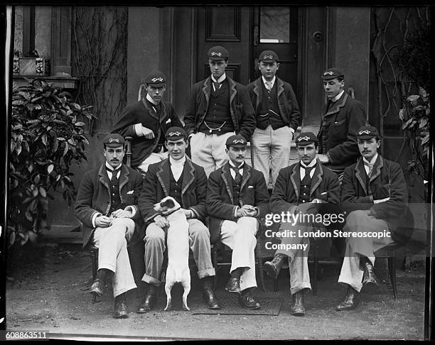 The Oxford University boat race crew pose with a Jack Russell, Oxford, UK, circa 1893.