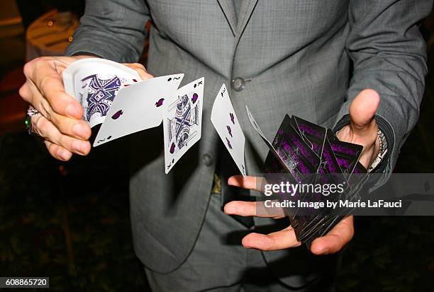 magician illusionist performing card trick - thinking of you card stock-fotos und bilder
