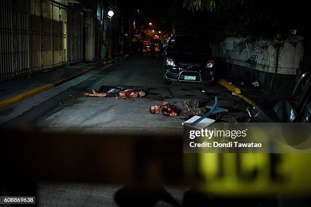 Two suspected hitmen lay dead on a street following an alleged shootout with police on September 9, 2016 in Manila, Philippines. The death toll from...