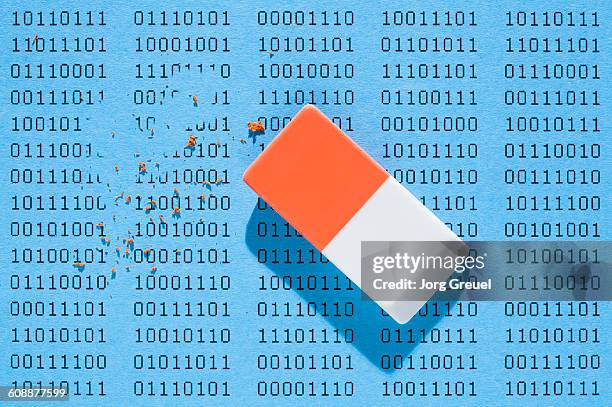 binary data being deleted by an eraser - goma de borrar fotografías e imágenes de stock