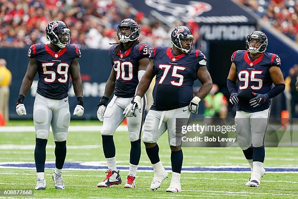 Whitney Merciless of the Houston Texans,Jadeveon Clowney,Vince Wilfork and Christian Covington wait for play to resume against the Kansas City Chiefs...