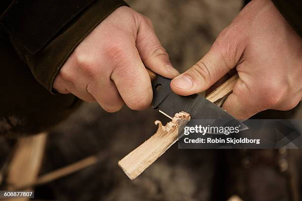 close up of hands with knive carving wood - survival stock pictures, royalty-free photos & images