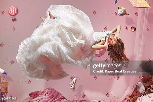 young girl in long white dress floating in bedroom - conto-de-fadas imagens e fotografias de stock