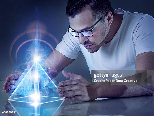 man holding modern pyramid projection with lasers - hologram projection stock pictures, royalty-free photos & images