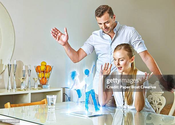 couple speaking with their children on a hologram - 3d daughter stock pictures, royalty-free photos & images