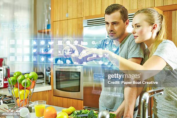 couple checking different apps on a hologram - 3d mom son stock pictures, royalty-free photos & images