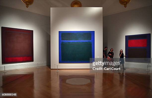 Visitors walk past paintings by U.S artist Mark Rothko entitled No. 64 ' , No. 15 and at the Royal Academy of Arts on September 20, 2016 in London,...