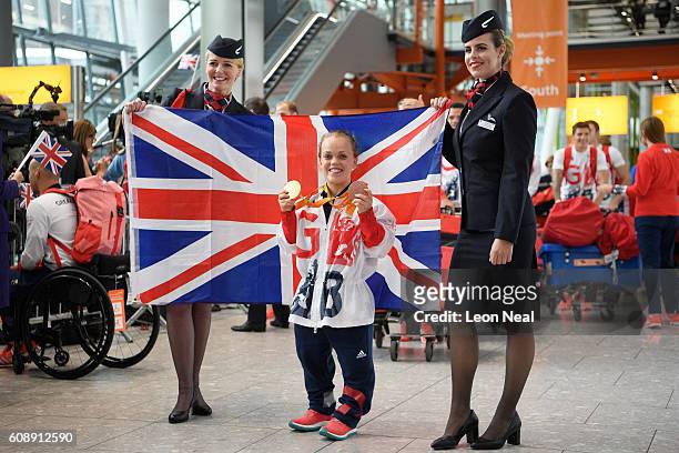 Gold medallist Ellie Simmonds poses with her medals after arriving on British Airways flight BA2016 from Rio de Janeiro to London Heathrow Terminal 5...