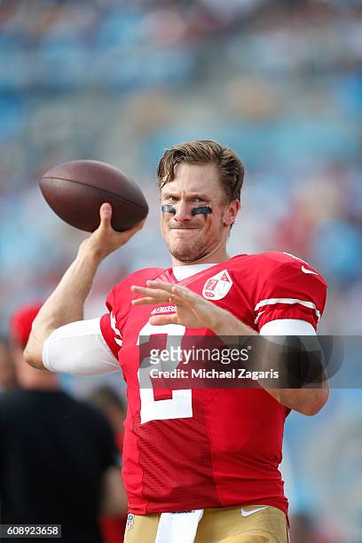 Blaine Gabbert of the San Francisco 49ers stays loose on the sideline during the game against the Carolina Panthers at Bank of America Stadium on...
