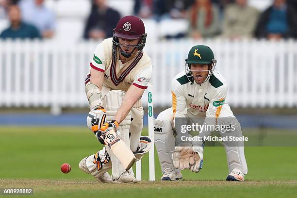 Chris Rogers of Somerset sweeps a delivery from Samit Patel as wicketkeeper Chris Read looks on during day one of the Specsavers County Championship...