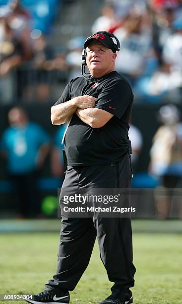 Head Coach Chip Kelly of the San Francisco 49ers stands on the field during the game against the Carolina Panthers at Bank of America Stadium on...
