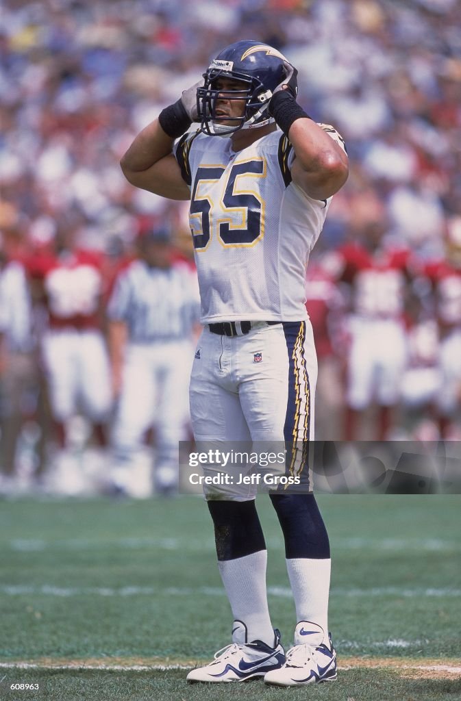 Jr. Seau Junior Seau of the San Diego Chargers makes sure his helmet in on ...