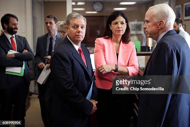Sen. Lindsey Graham , Sen. Kelly Ayotte and Sen. John McCain wait for the arrival of Sen. Ted Cruz before a news conference about military assistance...