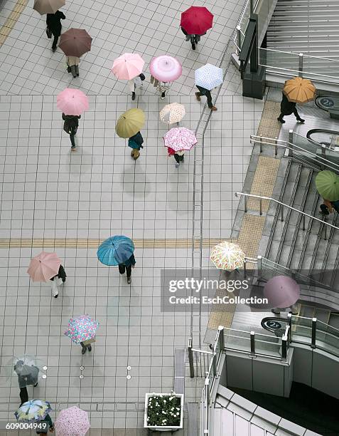 people with colorful umbrellas at centre of osaka - multi coloured umbrella stock pictures, royalty-free photos & images