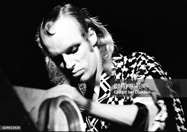 Brian Eno performing on stage at Shaw Theatre, London 1974.