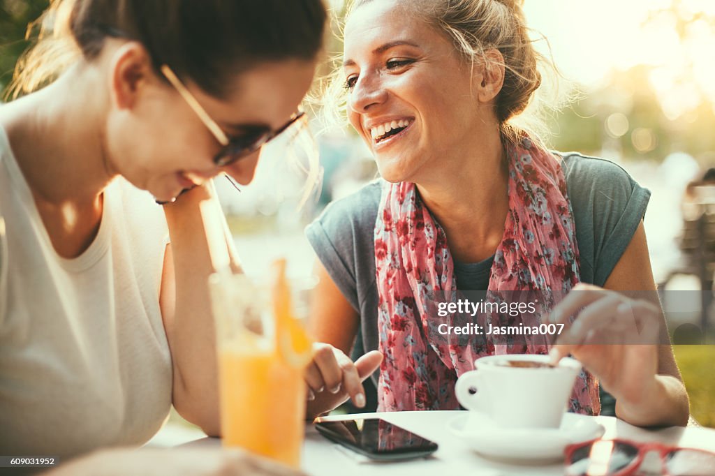 Female friends talking in cafe