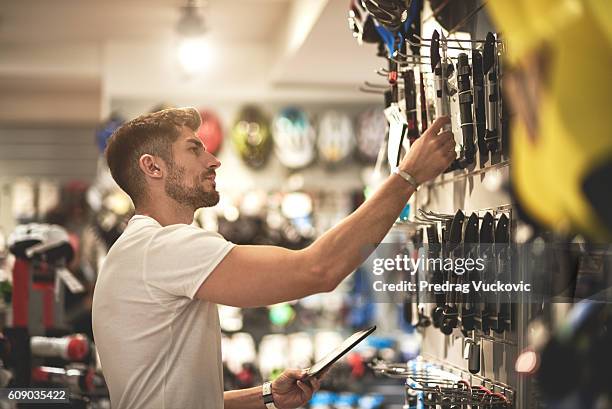 man in bicycle store - work tool stock pictures, royalty-free photos & images